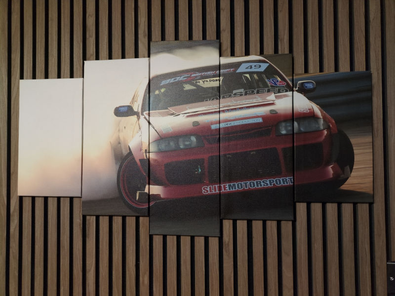 A metre-wide five-part split print of Adam Simmons' R33 drift car burning tyres.