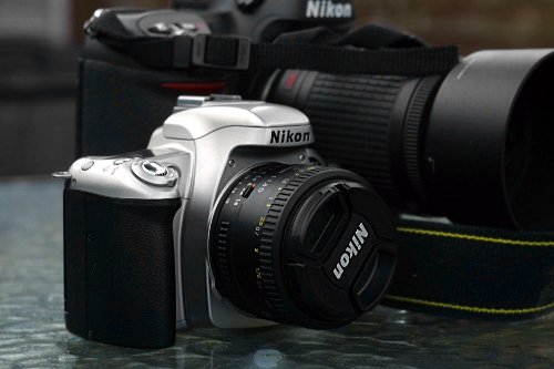Nikon F55 dwarfed by a huge digital SLR